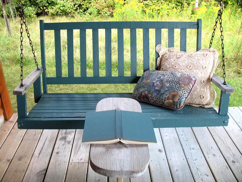 12 Ways to Add More Joy to Your Book-Reading Bliss, book on bench beside porch swing
